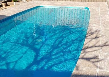 Residential pool painted in Luxapool epoxy turquoise colour in partial shade