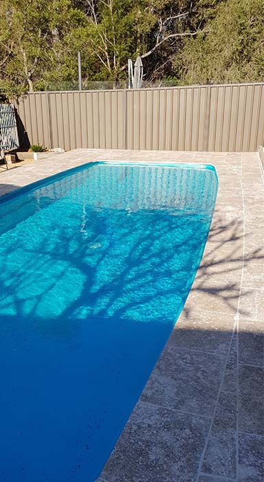 Residential pool painted in Luxapool epoxy turquoise colour in partial shade