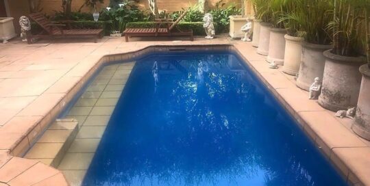 Residential pool painted with n LUXAPOOL Epoxy pool paint in Deep Ocean colour